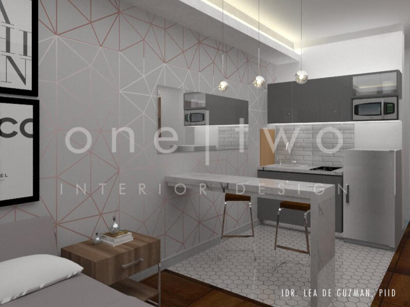 The living space is visually divided by a long bar table that corrals the kitchen from the bed.